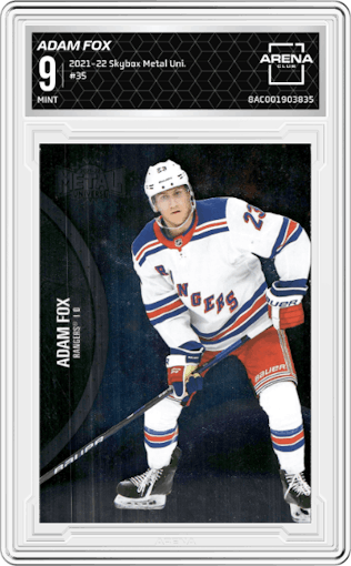 Adam Fox from the 2021-22 Skybox Metal Universe set graded by Arena Club and given an overall grade of 9.