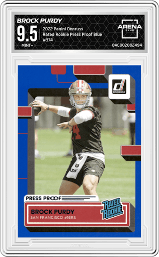 Brock Purdy from the 2022 Panini Donruss set featuring a Press Proof Blue parallel graded by Arena Club and given an overall grade of 9.5.