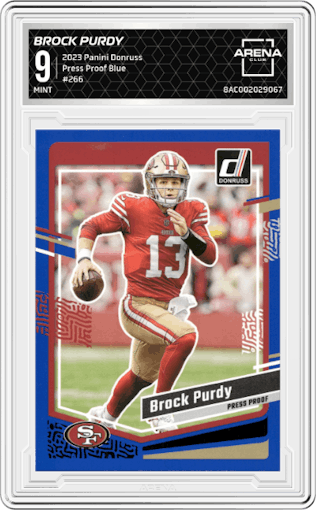 Brock Purdy from the 2023 Panini Donruss set featuring a Press Proof Blue parallel graded by Arena Club and given an overall grade of 9.