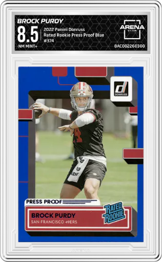Brock Purdy from the 2022 Panini Donruss set featuring a Press Proof Blue parallel graded by Arena Club and given an overall grade of 8.5.