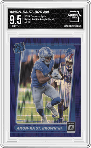 Amon-Ra St. Brown from the 2021 Panini Donruss Optic set featuring a Purple Shock parallel graded by Arena Club and given an overall grade of 9.5.