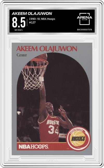 Akeem Olajuwon from the 1990-91 NBA Hoops set graded by Arena Club and given an overall grade of 8.5.