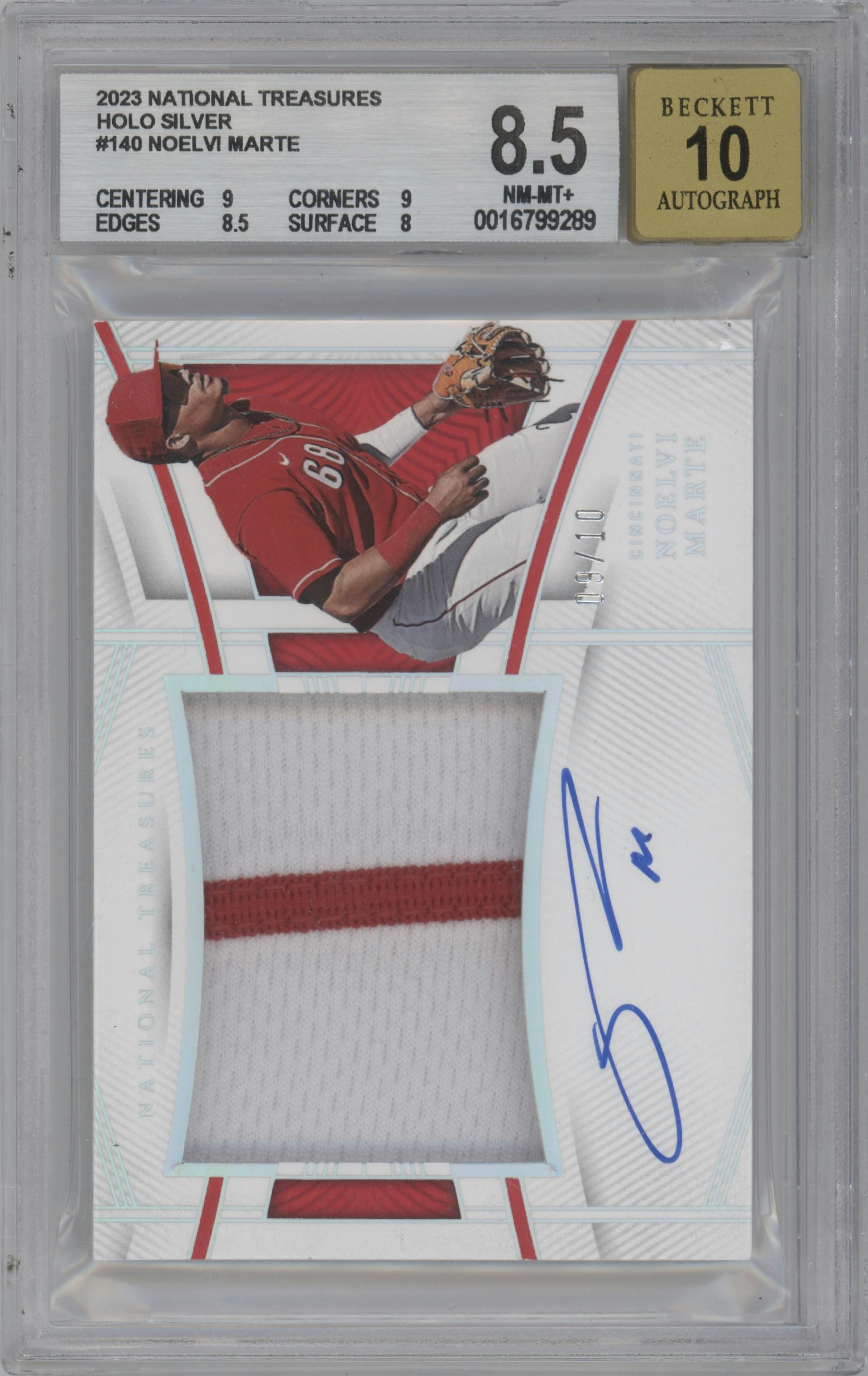 Noelvi Marte from the 2023 Panini National Treasures set featuring a Holo Silver parallel graded by Beckett and given an overall grade of 8.5.