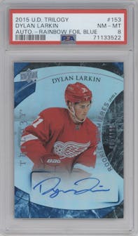 Dylan Larkin from the 2015-16 Upper Deck Trilogy set featuring a Blue Rainbow Foil parallel graded by PSA and given an overall grade of 8.