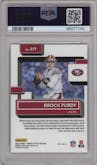 Brock Purdy from the 2022 Panini Donruss Optic set featuring a Purple Shock parallel graded by PSA and given an overall grade of 9.