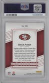 Brock Purdy  from the 2022 Panini Donruss Elite set featuring a Status Explosion parallel graded by PSA and given an overall grade of 10.