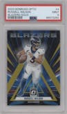 Russell Wilson from the 2023 Donruss Optic set featuring a Gold parallel graded by PSA and given an overall grade of 9.
