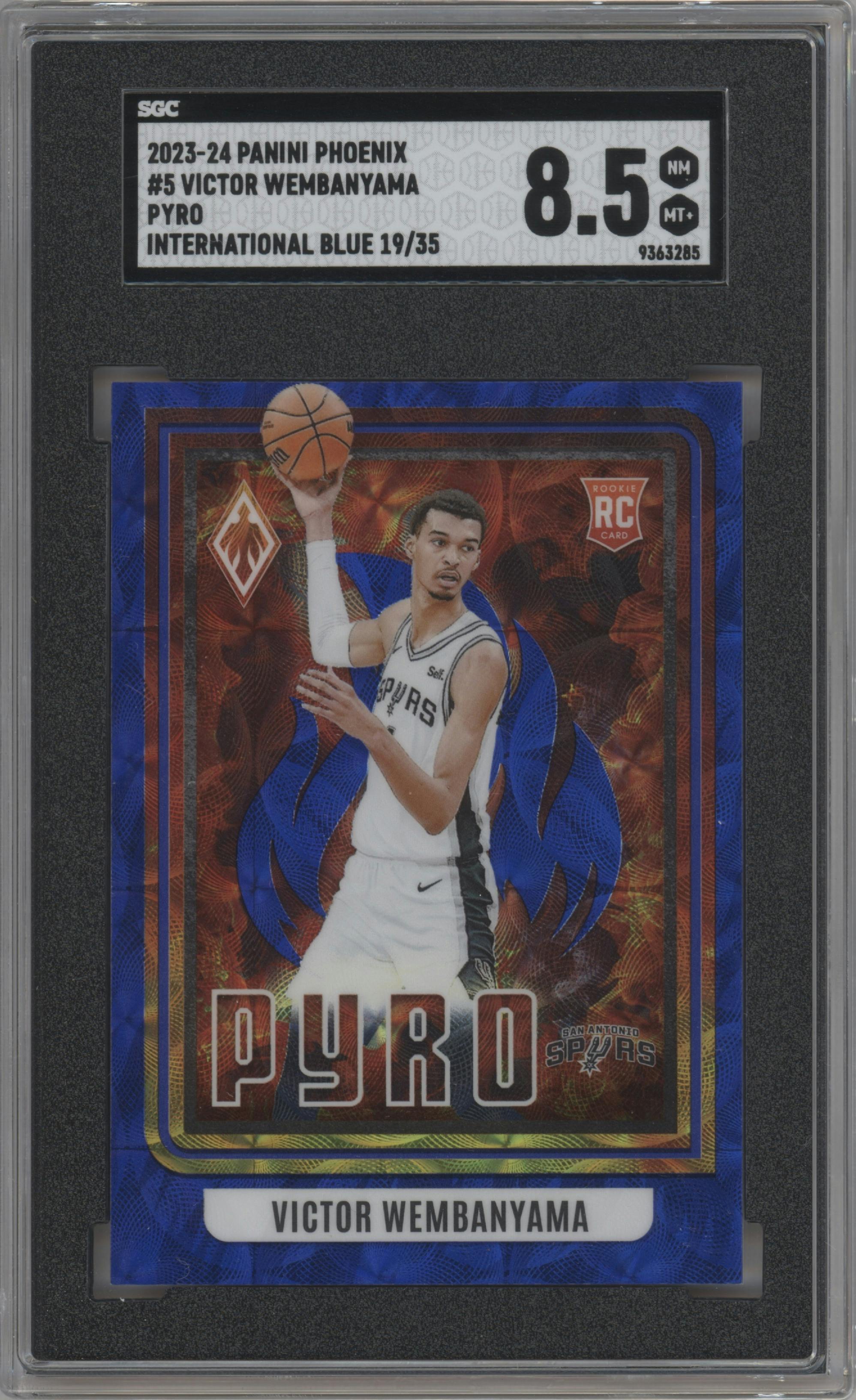 Victor Wembanyama from the 2023-24 Panini Phoenix set featuring a International Blue parallel graded by SGC and given an overall grade of 8.5.