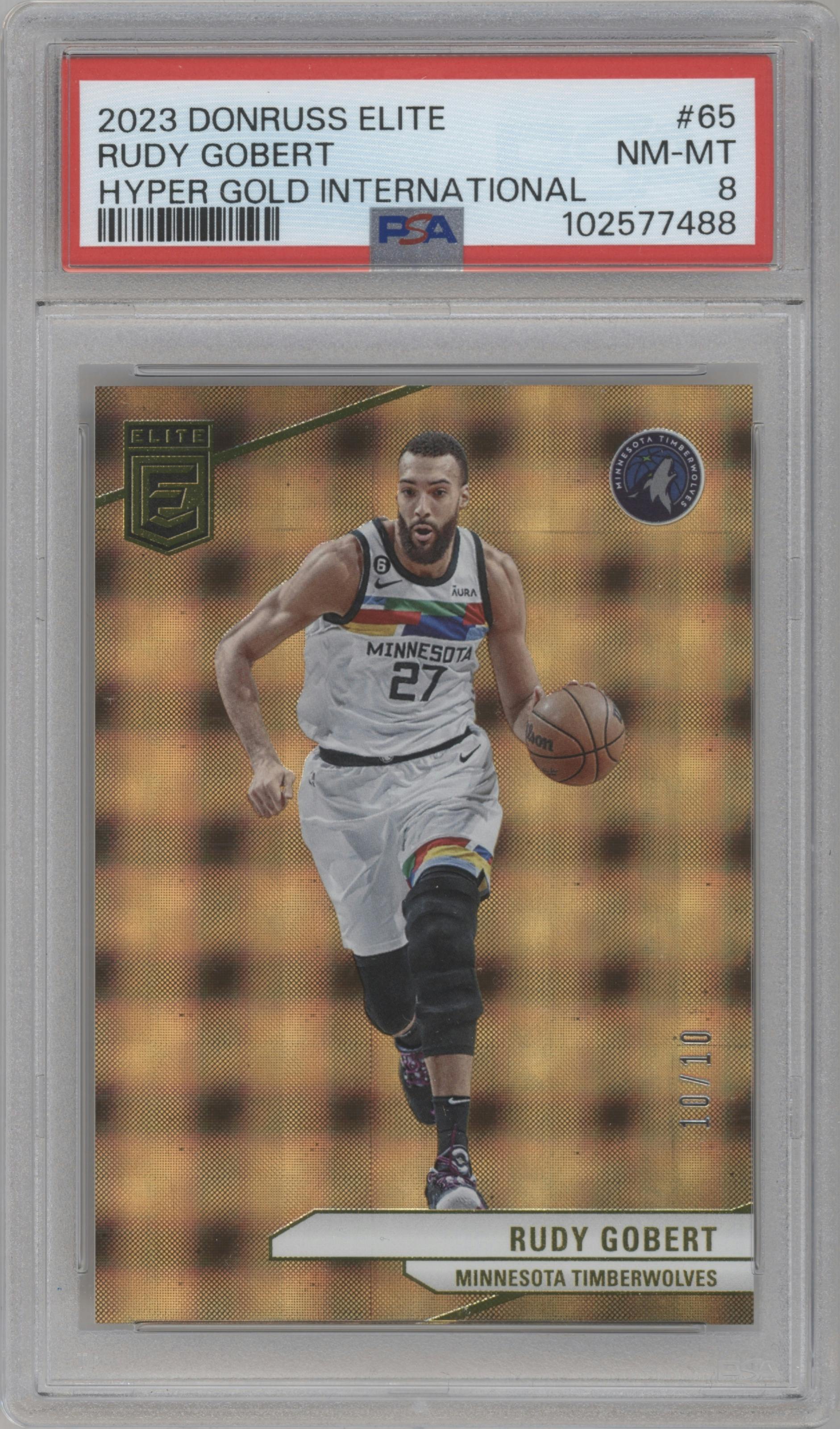 Rudy Gobert from the 2023-24 Panini Donruss Elite set featuring a International Hyper Gold parallel graded by PSA and given an overall grade of 8.