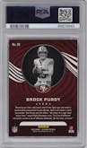 Brock Purdy from the 2023 Panini Illusions set featuring a Trophy Collection Orange  parallel graded by PSA and given an overall grade of 10.