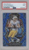 Justin Herbert from the 2022 Panini Select set featuring a Blue Disco Prizm parallel graded by PSA and given an overall grade of 9.