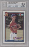 Chipper Jones from the 1991 Topps set featuring a Desert Shield parallel graded by Beckett and given an overall grade of 8.5.