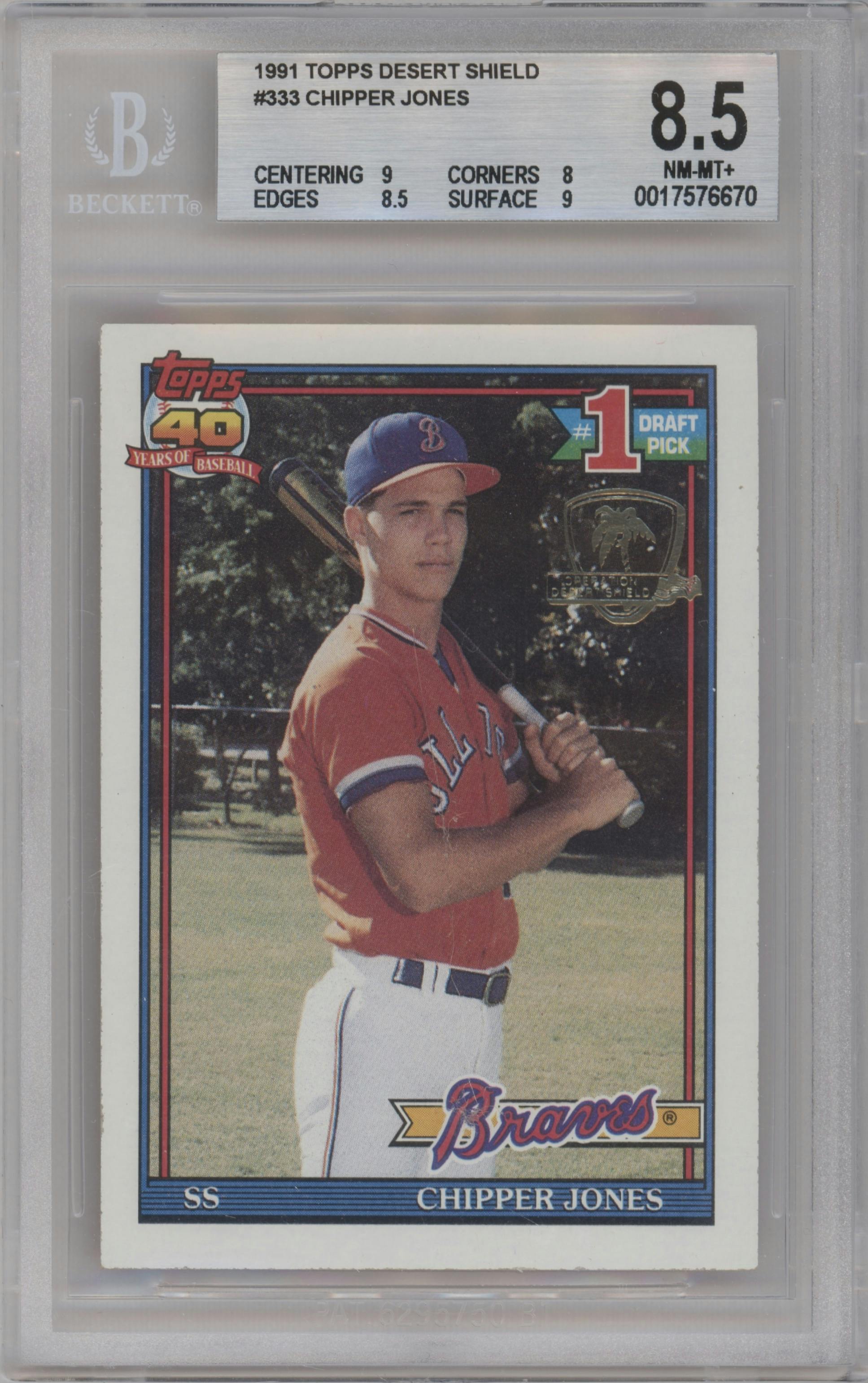 Chipper Jones from the 1991 Topps set featuring a Desert Shield parallel graded by Beckett and given an overall grade of 8.5.