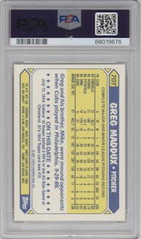 Greg Maddux from the 1987 Topps Traded set featuring a Tiffany parallel graded by PSA and given an overall grade of 8.