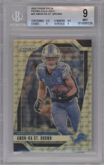 Amon-Ra St. Brown  from the 2024 Panini Prizm set featuring a Gold Vinyl parallel graded by Beckett and given an overall grade of 9.