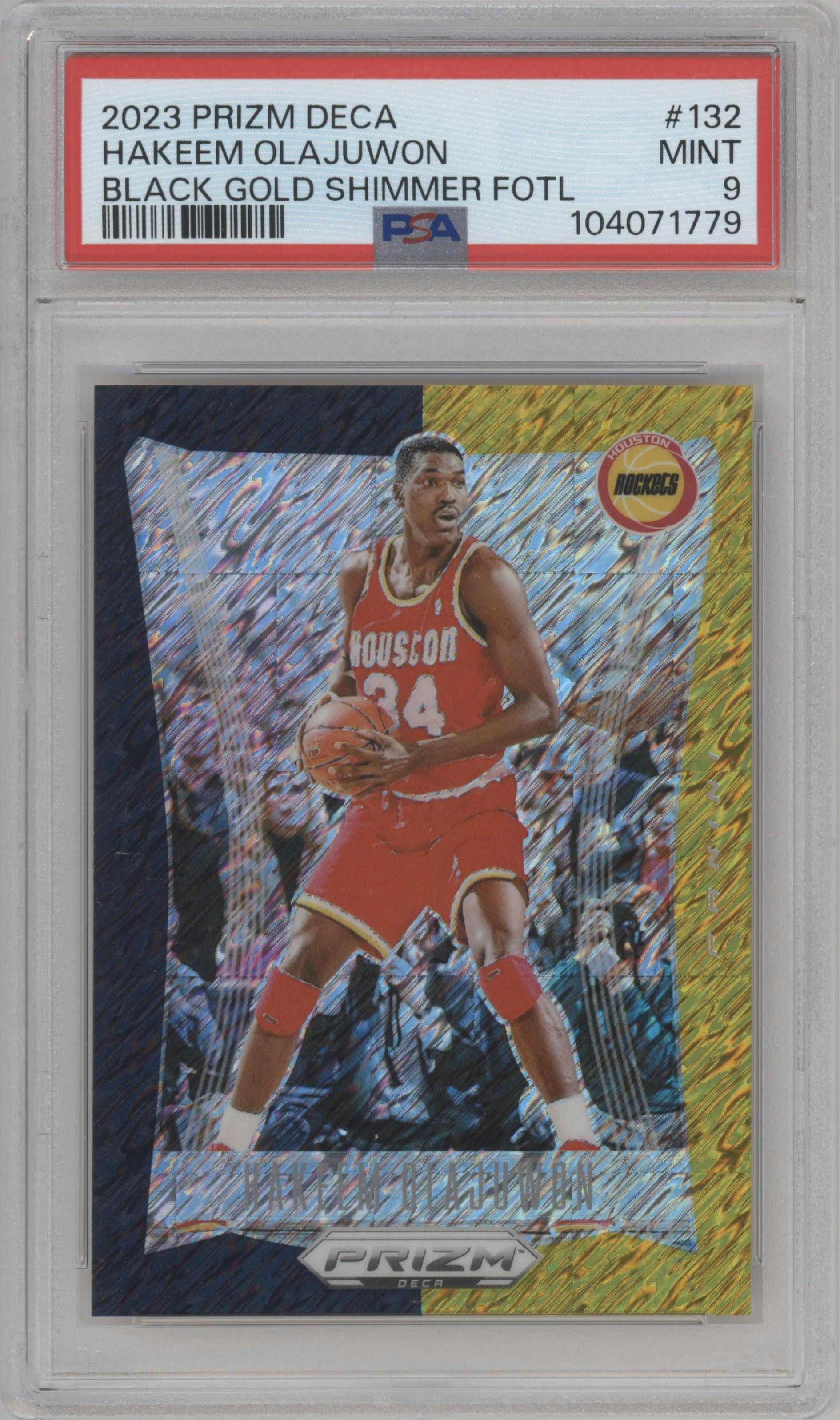 Hakeem Olajuwon from the 2023-24 Panini Prizm Deca set featuring a FOTL Black Gold Shimmer Prizm  parallel graded by PSA and given an overall grade of 9.