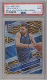Luka Doncic  from the 2023-24 Panini Spectra set featuring a Red & Yellow International parallel graded by PSA and given an overall grade of 9.