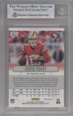 Brock Purdy from the 2023 Panini Prizm set featuring a Gold parallel graded by Beckett and given an overall grade of 9.