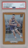 Devin Booker from the 2023-24 Panini Prizm Deca set featuring a Orange Prizm parallel graded by PSA and given an overall grade of 10.