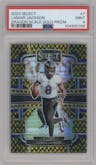 Lamar Jackson from the 2023 Panini Select set featuring a Gold Dragon Scale parallel graded by PSA and given an overall grade of 9.